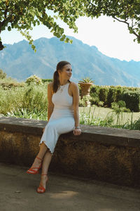 Young woman sitting on bench