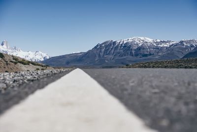 Scenic view of snow covered mountains against clear sky