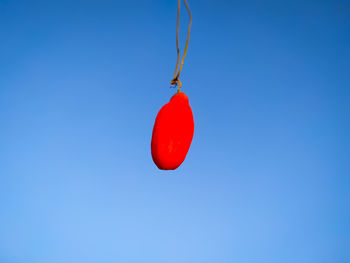 Low angle view of heart shape against blue sky