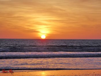 Scenic view of sea against orange sky