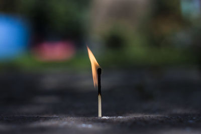 Close-up of burning matchstick