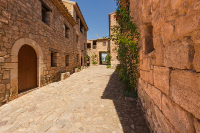 Alley amidst buildings against sky