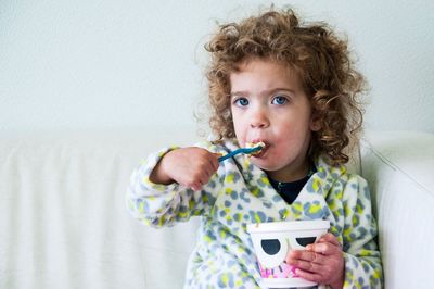 Portrait of toddler eating at home