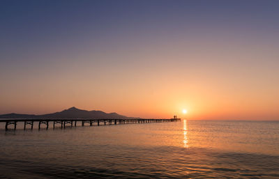 Scenic view of sea against orange sky