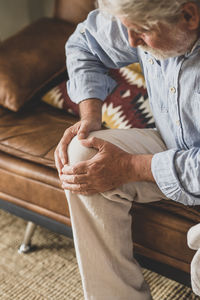 Portrait of boy sitting on sofa at home