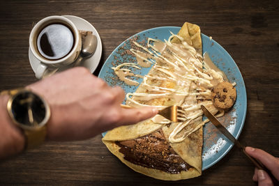 Cropped image of hand holding breakfast