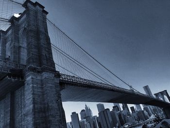 Low angle view of suspension bridge against sky