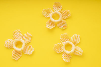 Close-up of yellow art on table