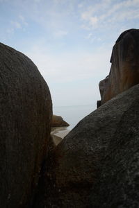 Rock formations by sea against sky