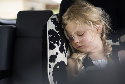 Tired girl sleeping in car