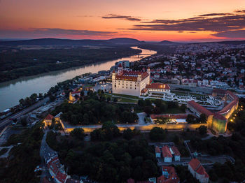 High angle view of illuminated buildings against sky during sunset