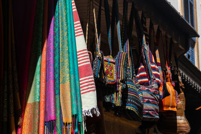 Multi colored flags hanging in store for sale at market stall