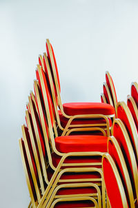 Red chairs stacked against white background