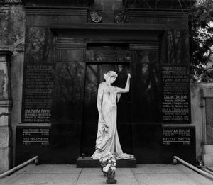 Memorial with text mounted wall with statue at park