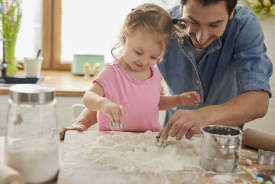 Family preparing food in kitchen