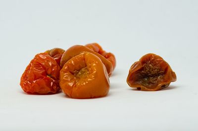 Close-up of orange slices against white background