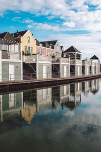 Buildings by swimming pool against sky