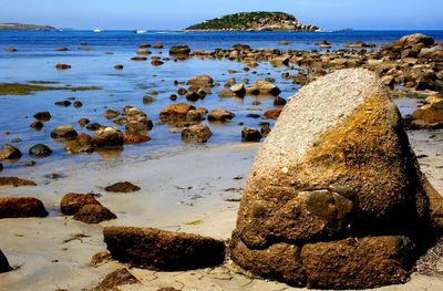 Rocks on beach against sky