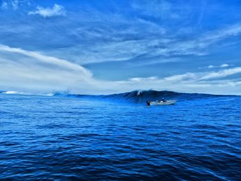 Scenic view of sea against blue sky