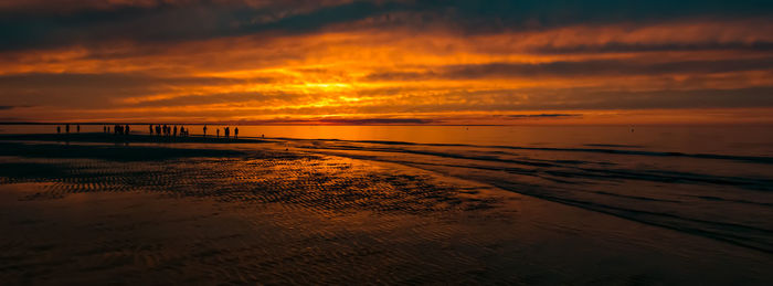 Scenic view of beach against sky during sunset