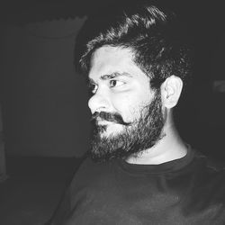 Portrait of young man looking away at home