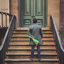 Full length of woman standing by railing