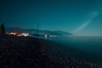 Scenic view of sea against clear blue sky at night