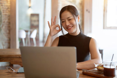 Young woman using laptop on table