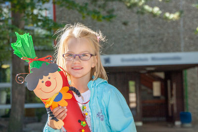 Portrait of smiling girl holding umbrella