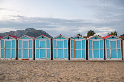 Little blue houses on the beach.  sunset on the mediterranean coast. old cracked paint