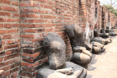 Statue against stone wall