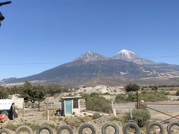 Scenic view of mountains against clear blue sky