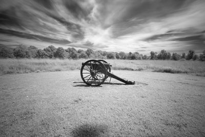 Bicycle on field against sky