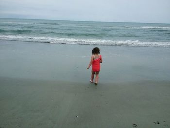 Rear view of girl on beach