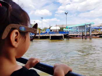 Portrait of woman in boat against sky