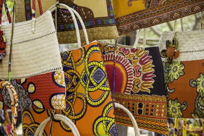 Colorful bags hanging at market for sale