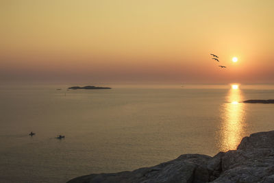 Scenic view of sea against sky during sunset