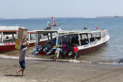 People on beach against sky