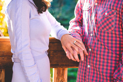 Midsection of couple standing outdoors