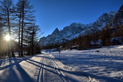 Snow covered landscape against sky