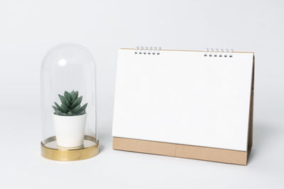 Close-up of glasses on table against white background