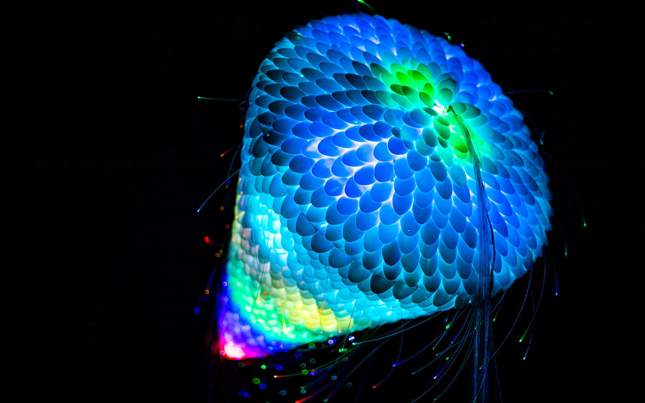 LOW ANGLE VIEW OF ILLUMINATED LIGHTS AGAINST BLACK BACKGROUND