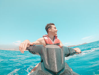 Man by sea against sky