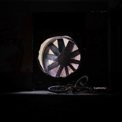 Close-up of electric lamp on wall at home