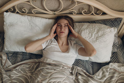 High angle view of woman sleeping on bed at home