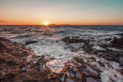 Scenic view of sea against clear sky during sunset