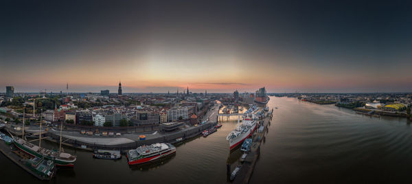 High angle view of illuminated buildings in city during sunset