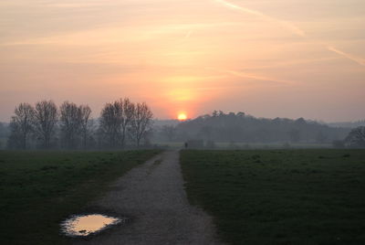 Scenic view of field against sky during sunset