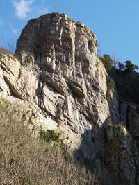Low angle view of rock formations against sky