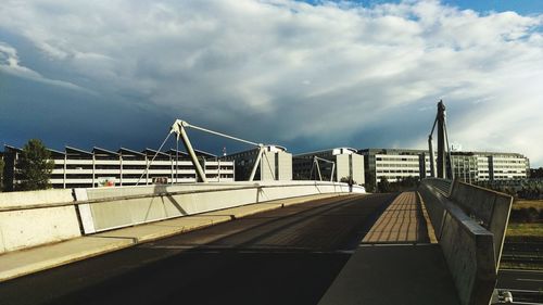 Bridge over water in city against sky